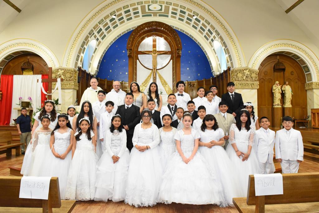 Photo of children who have received their First Communion standing in the front of church.